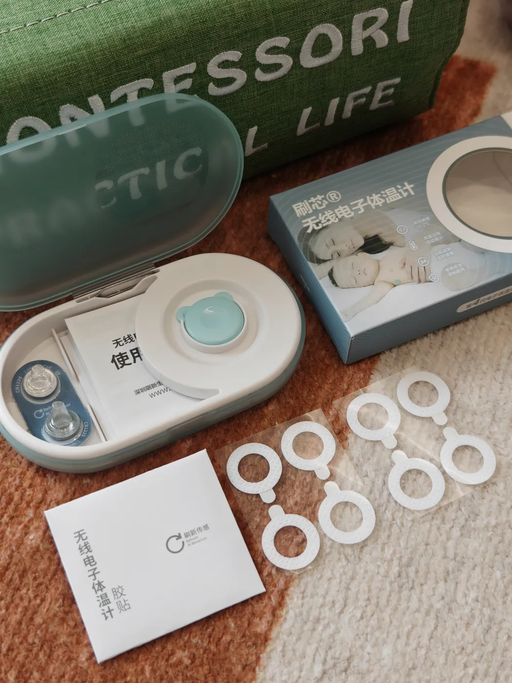 P20 wearable thermometer retail kit unboxed — sensor, storage case, hypoallergenic patches, CR1225 battery and manual