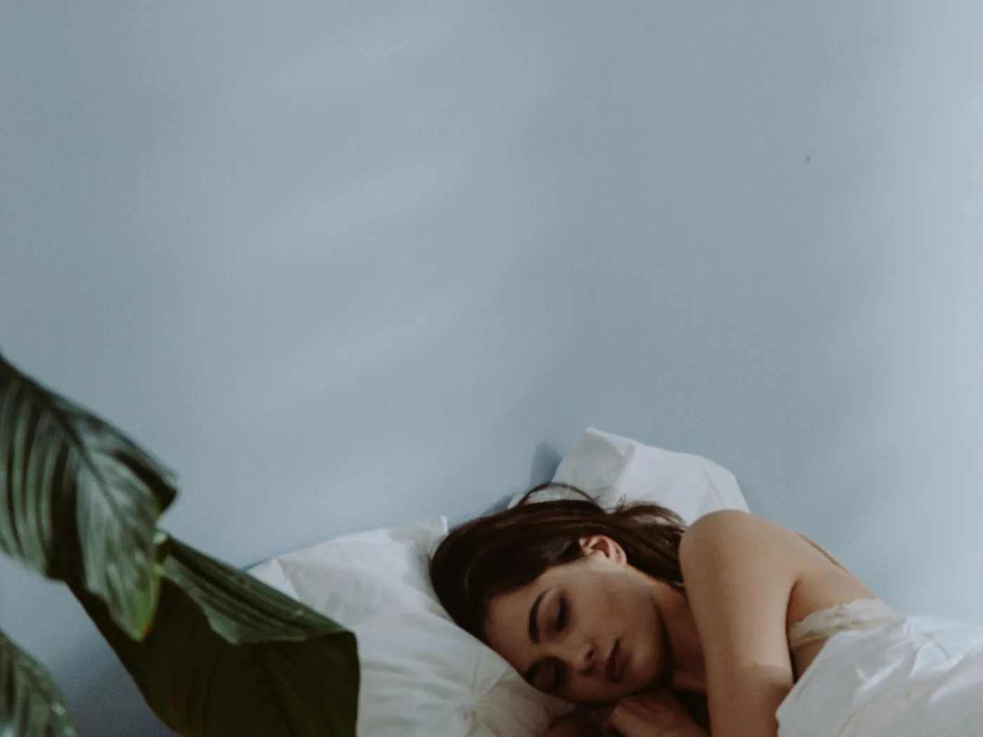 Woman asleep while the wearable sensor records her overnight temperature
